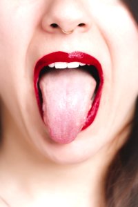 Photo Of Woman Showing Her Tongue photo