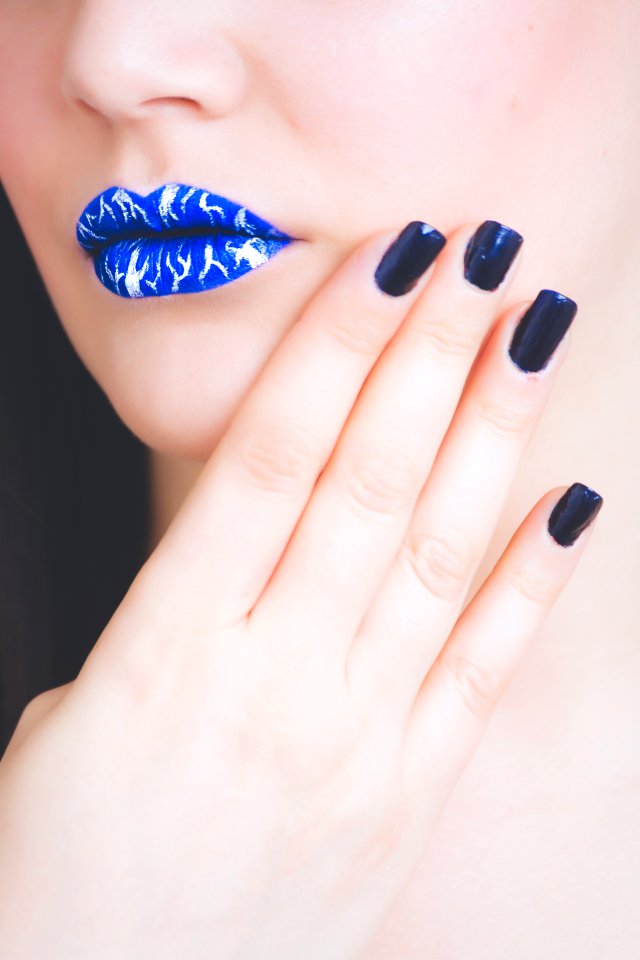 Woman Wearing Blue And White Lipstick With Black Manicure