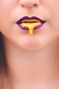 Yellow Liquid On Womans Lips photo