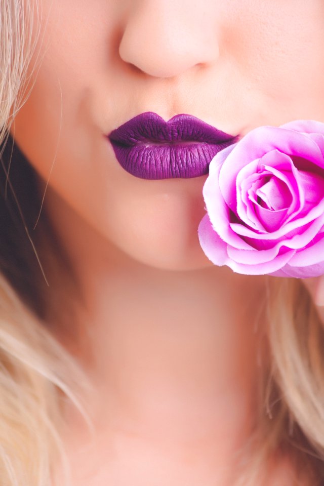 Woman Wearing Purple Lipstick With Pink Rose On Her Cheeks