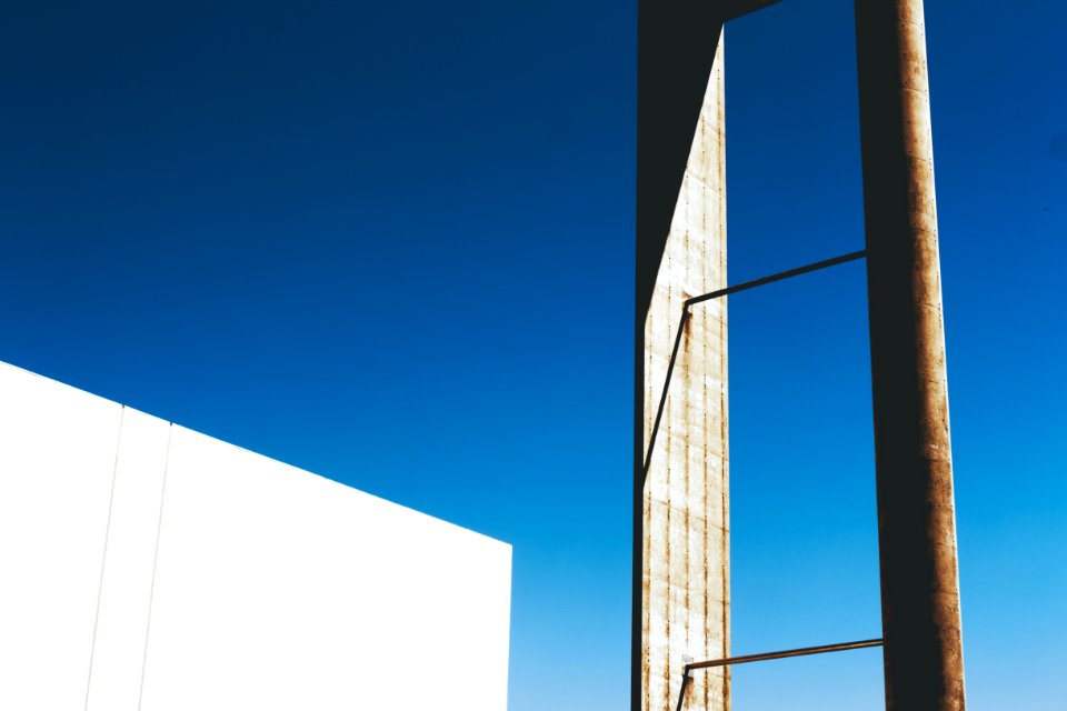 White And Brown Steel Tube Near White Wall