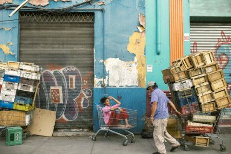 Man Wearing Gray Cap And Blue Shirt Holding Shopping Cart