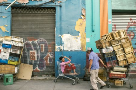 Man Wearing Gray Cap And Blue Shirt Holding Shopping Cart photo