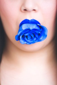 Blue Rose Flower On Womans Mouth photo