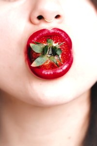 Woman With Strawberry On Mouth photo
