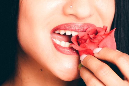 Woman Biting The Red Rose