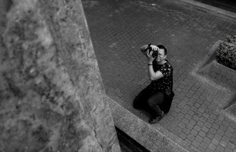 Grayscale Photography Of Man Taking Picture photo