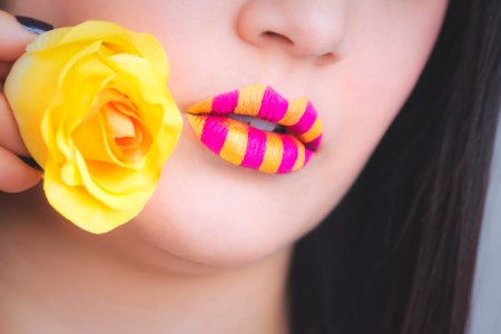 Woman Wearing Pink And Yellow Stripe Lipstick