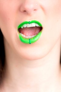 Woman Wearing Green Lipstick With An Open Mouth photo