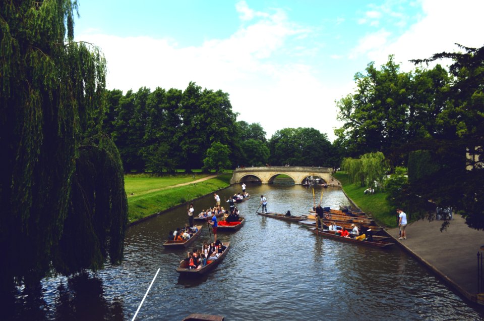 Group Of People Ride On Jon Boats Near Bridge
