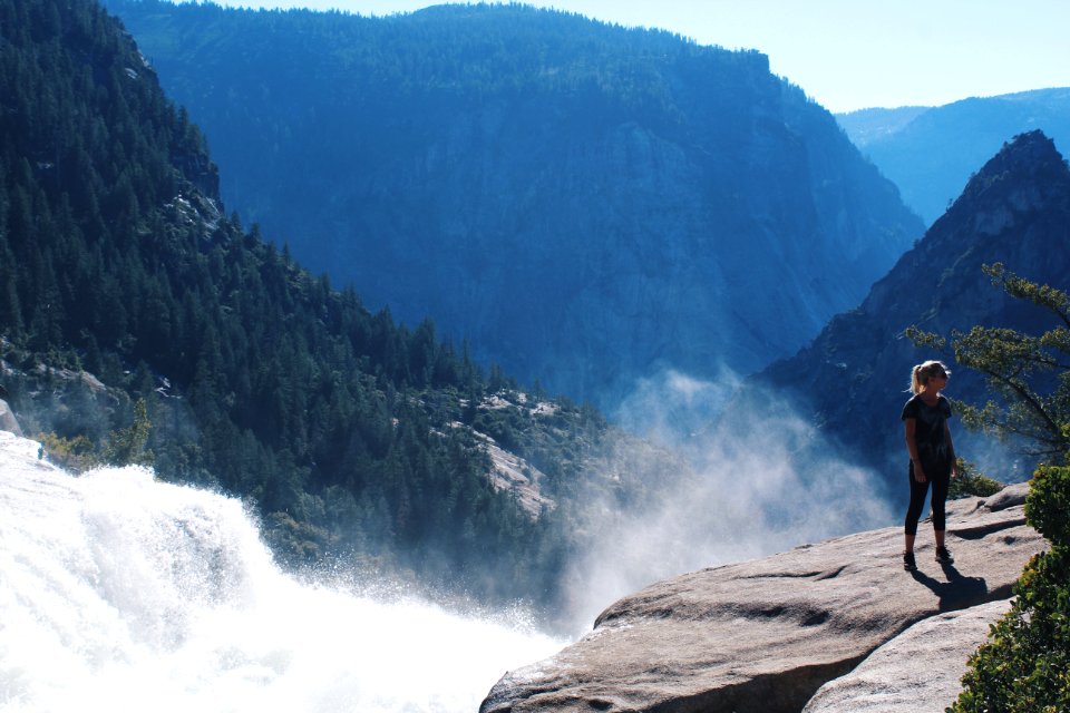 Woman Standing Near Mountain Cliff