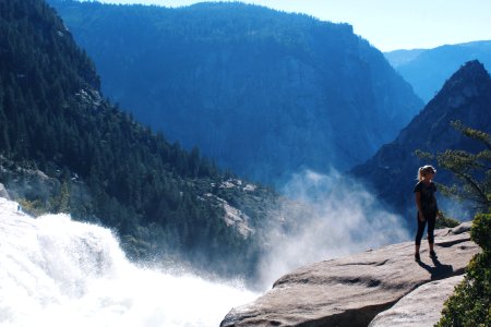 Woman Standing Near Mountain Cliff photo