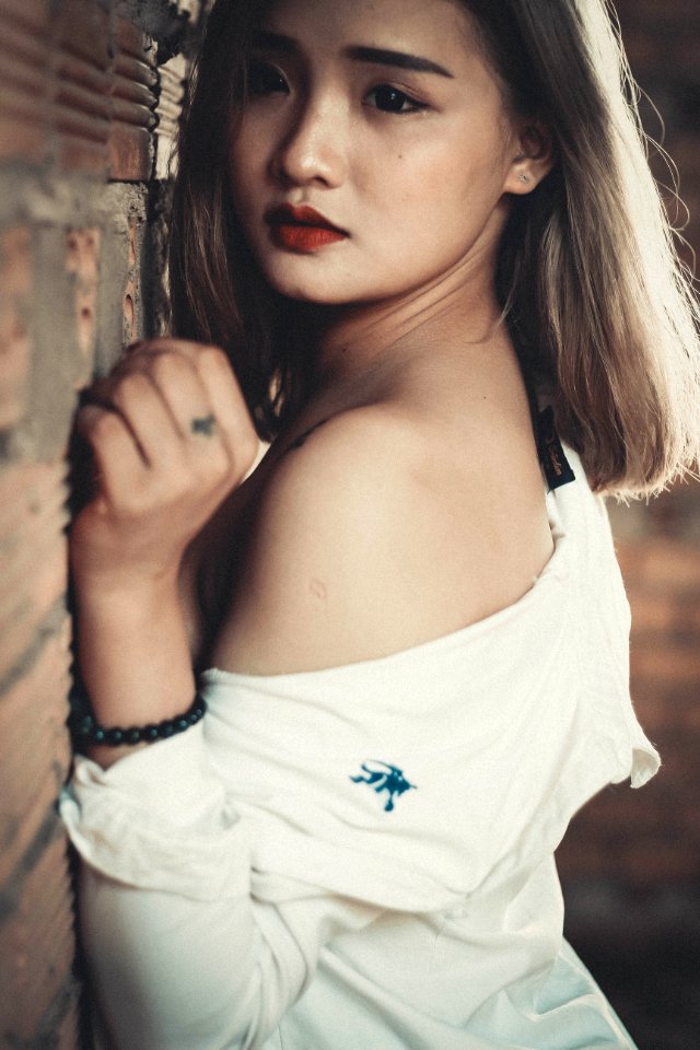 Shallow Focus Photography Of Woman In White Off-shoulder Top