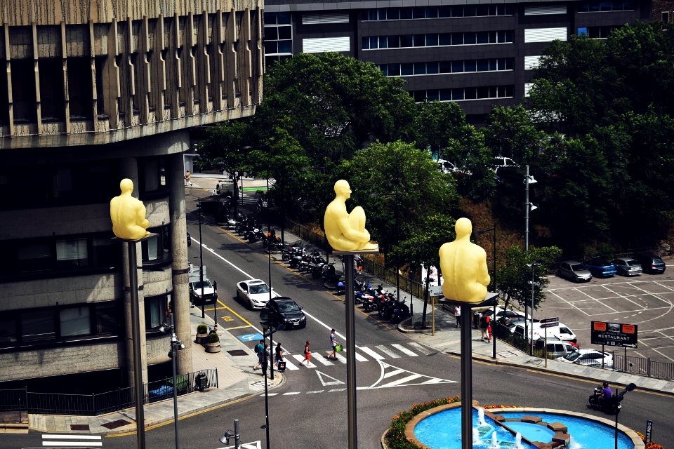 Birds Eye View Photo Of Sitting Statues On Outdoor Post