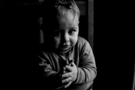 Grayscale Photo Of Baby Sitting On Chair