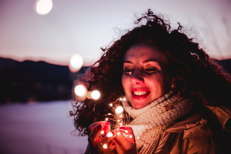 Woman Holding White String Lights