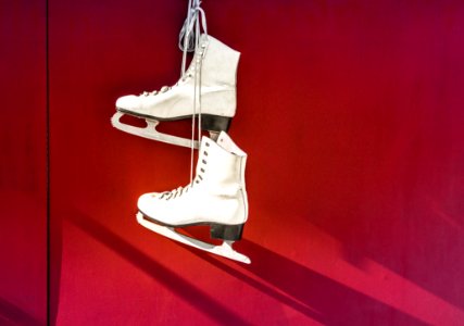 Hanged Pair Of White Leather Figure Skates photo