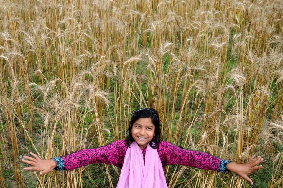 Woman Taking Selfie In Brown Grass Field