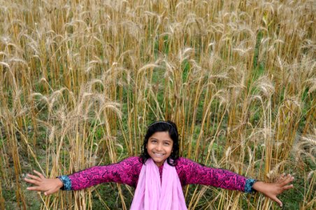 Woman Taking Selfie In Brown Grass Field