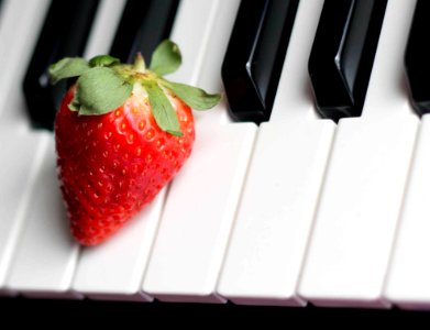 Strawberry On Top Of Piano Keys