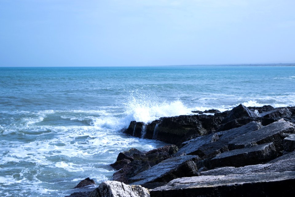 Black Rock Natural Formation Front Of Sea photo