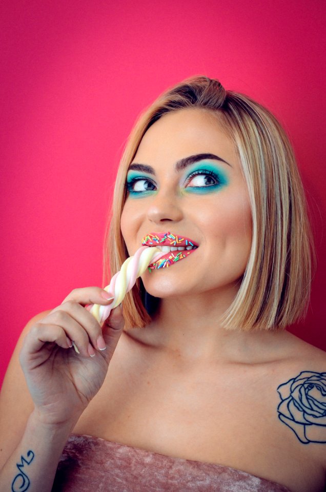Woman Eating Yellow And Pink Marshmallow