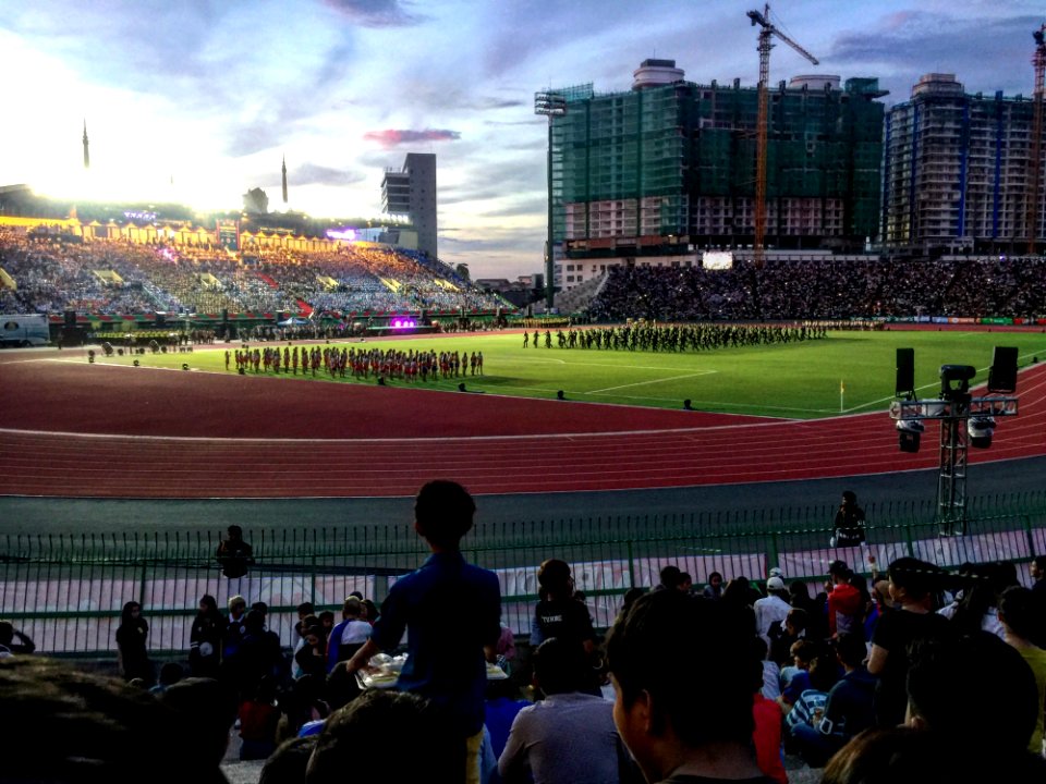 Group Of People Watching Football Player Team On Field