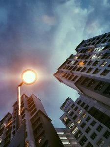 Low Angle Photography Of Lamp Post Beside Building Under Cloudy Sky photo