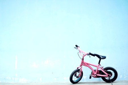 Toddlers Pink Bike Near Wall photo