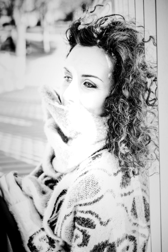 Grayscale Photo Of Woman Wearing Knitted Top