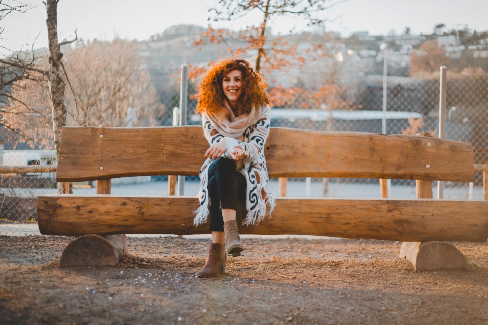 Woman Wearing Floral Cardigan Sit On Bench