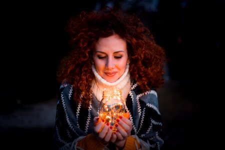 Woman Holding Clear Glass Jar Filled With Lights photo