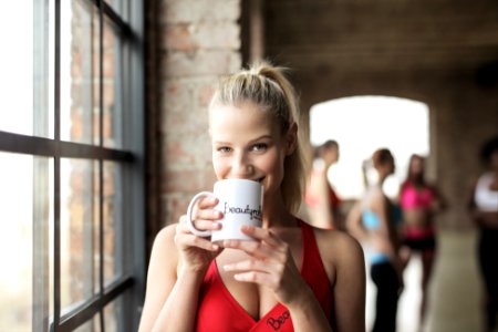 Woman In Red Scoop-neck Tank Top Holding White Mug