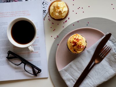 Top-view Photograph Of Two Cupcakes Cup And Eyeglasses photo