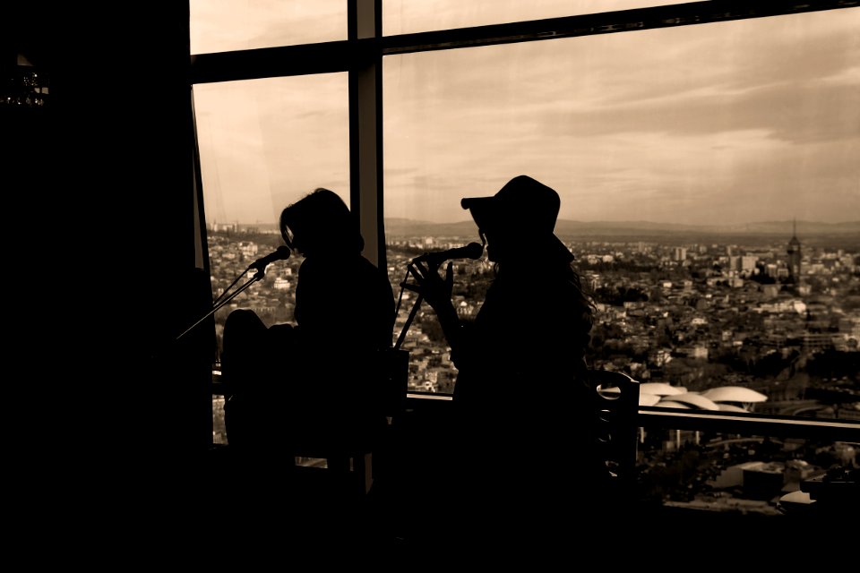 Silhouette Of Two Women Singing In Sepia Photography