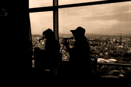 Silhouette Of Two Women Singing In Sepia Photography