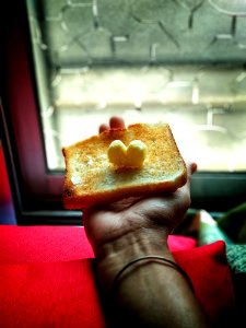 Person Holding Toast With Butter On Top
