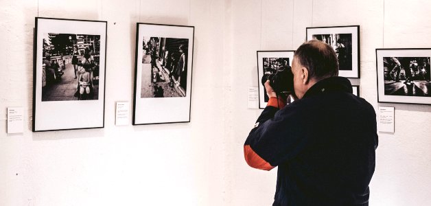 Man Taking Photo Inside Exhibit Room photo