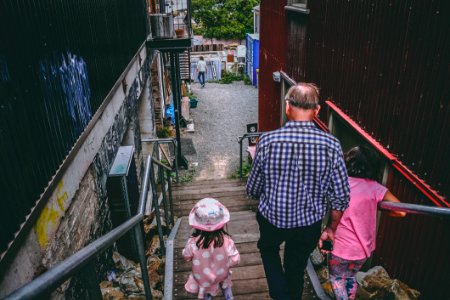 Man And Two Girls Walking Down On Stairs photo