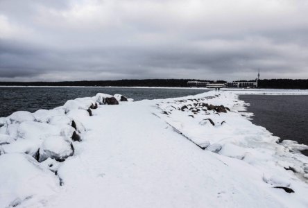 Pathway Between Body Of Water Filled With Snow photo