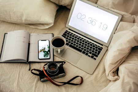 Macbook Air Beside Notebook And Camera photo