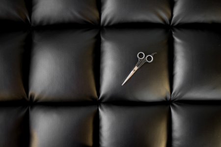 Photo Of Scissor On Black Leather Cushion