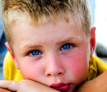 Close-Up Photography Of Boy With Blue Eyes photo