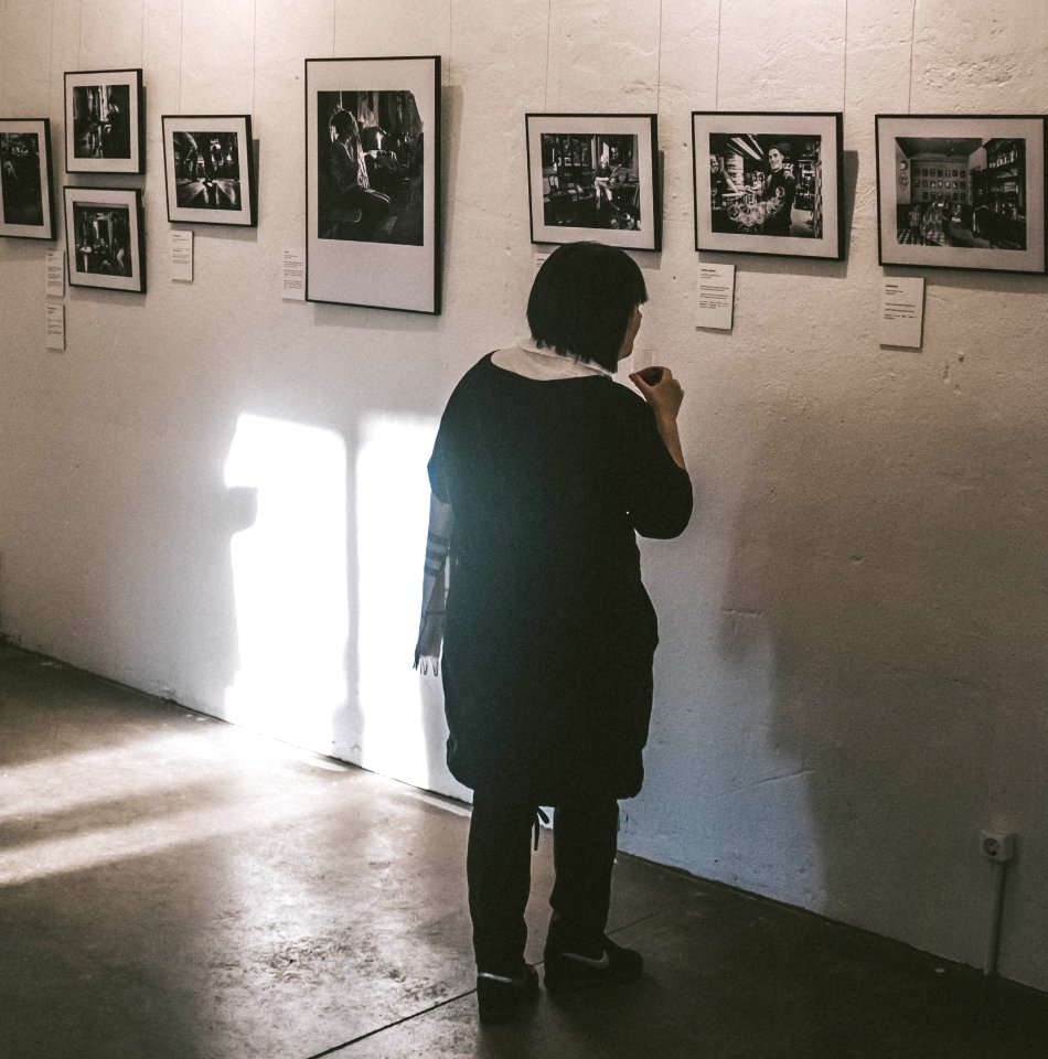 Standing Woman Looking At Photos