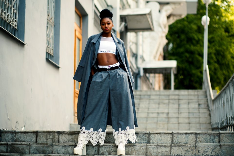 Woman Wearing Gray Coat And White Crop Top On Staircase