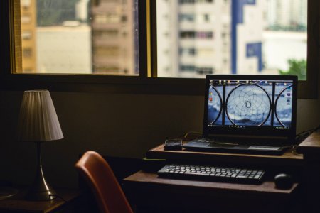 Black Laptop Computer Turned On Near Window At Daytime photo
