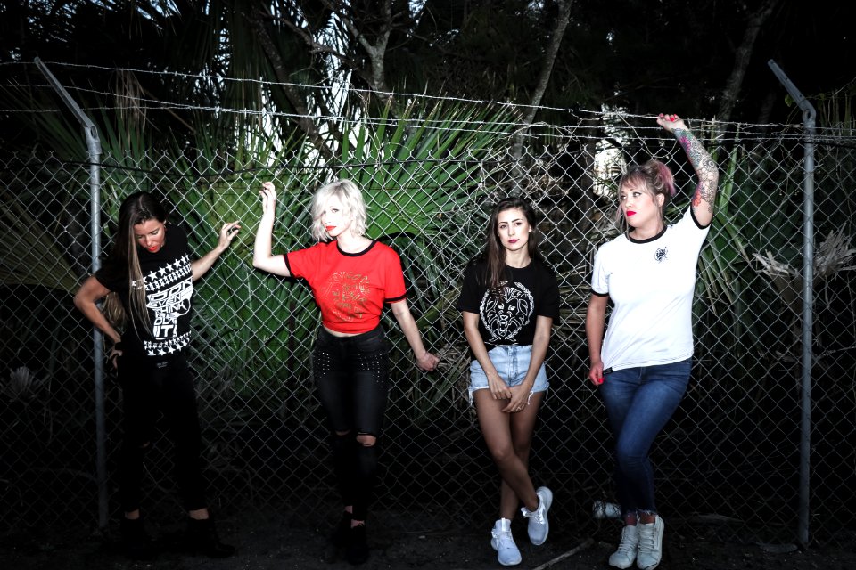 Group Of Women Beside Stainless Steel Cyclone Fence