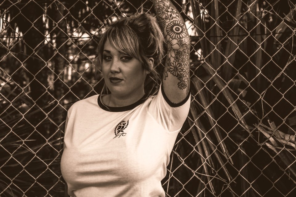 Women In White T-shirt Standing Near Fence
