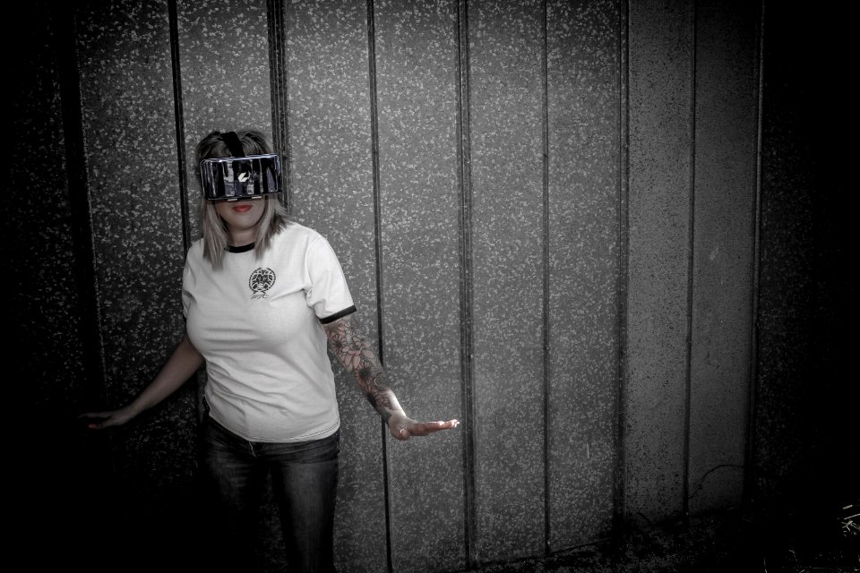 Woman Wearing Virtual Reality Headset Standing Beside Wall