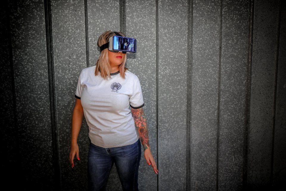 Photograph Of Woman Wearing Vr Glass In Front Of Wall